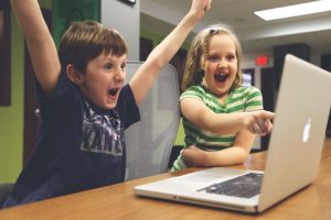 Two young children excited to receive good email marketing.